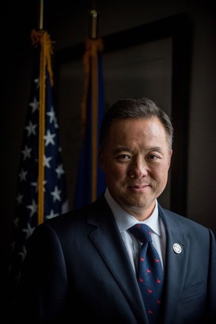 Asian American man in suit at AAPI History Museum anniversary event.